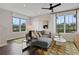 Living room with grey sectional sofa, large windows, and hardwood floors at 13243 Peaceful Melody Dr, Winter Garden, FL 34787