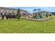 Community playground with playset and benches at 13243 Peaceful Melody Dr, Winter Garden, FL 34787