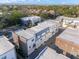 Aerial view of townhouses with flat roofs and brick exteriors, near water at 133 S Park Ave, Winter Garden, FL 34787