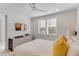 Comfortable and stylish bedroom featuring a dresser, TV and large windows at 133 S Park Ave, Winter Garden, FL 34787