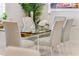 Elegant dining room featuring a glass table and six contemporary chairs at 133 S Park Ave, Winter Garden, FL 34787