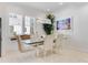 Bright dining room with glass table and modern chairs, showcasing stylish decor at 133 S Park Ave, Winter Garden, FL 34787