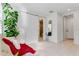 Bright and airy home office features a comfortable red chair and a modern sliding barn door at 133 S Park Ave, Winter Garden, FL 34787