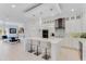 Bright white kitchen with island, breakfast bar, and stainless steel appliances at 133 S Park Ave, Winter Garden, FL 34787