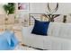 Modern white sofa with blue pillows in a bright, open living space at 133 S Park Ave, Winter Garden, FL 34787