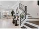 Modern staircase with sleek metal railing and glass top table at 133 S Park Ave, Winter Garden, FL 34787