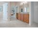 Bathroom with double vanity and access to the main bedroom and hallway at 1369 Harley Cir, The Villages, FL 32162