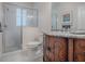 Bathroom with granite vanity and walk-in shower at 1369 Harley Cir, The Villages, FL 32162