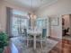 Elegant dining room with a large table, chandelier, and hardwood floors at 1369 Harley Cir, The Villages, FL 32162