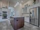 Updated kitchen featuring stainless steel appliances and ample cabinet space at 1369 Harley Cir, The Villages, FL 32162