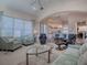 Spacious living room featuring comfortable seating and a view into the kitchen at 1369 Harley Cir, The Villages, FL 32162