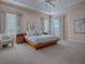 Relaxing main bedroom with a wooden platform bed and ample natural light at 1369 Harley Cir, The Villages, FL 32162