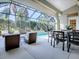 Outdoor patio dining area with glass table and chairs at 1369 Harley Cir, The Villages, FL 32162