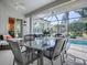 Outdoor patio dining area with glass table and chairs at 1369 Harley Cir, The Villages, FL 32162