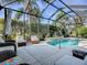 Screened pool area with patio furniture at 1369 Harley Cir, The Villages, FL 32162