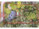 A bird's eye view of a home with a pool nestled within a vibrant green forest at 1701 Cedar Stone Ct, Lake Mary, FL 32746
