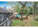 Home and in-ground pool with lounge furniture and trees providing shade and privacy at 1701 Cedar Stone Ct, Lake Mary, FL 32746