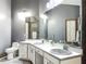 Bathroom vanity with double sinks, mirror and soft lighting for a bright, functional space at 1701 Cedar Stone Ct, Lake Mary, FL 32746