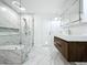 Modern bathroom featuring a glass shower, marble floors and walls, floating vanity, and mirrored cabinets at 1701 Cedar Stone Ct, Lake Mary, FL 32746