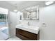Modern bathroom with glass shower and rain shower head, floating vanity, and illuminated mirrored medicine cabinet at 1701 Cedar Stone Ct, Lake Mary, FL 32746