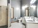 Bathroom with a spacious walk-in shower, dual sinks, and large mirror, offering a luxurious feel at 1701 Cedar Stone Ct, Lake Mary, FL 32746