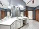Bright bathroom features double vanity, lots of mirrors and updated fixtures at 1701 Cedar Stone Ct, Lake Mary, FL 32746