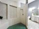 Bright bathroom featuring a walk in shower with green tiling, and an adjacent vanity at 1701 Cedar Stone Ct, Lake Mary, FL 32746