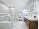 Modern bathroom featuring marble walls, a glass shower with bench, and floating vanity with sleek lighting at 1701 Cedar Stone Ct, Lake Mary, FL 32746