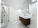 Modern bathroom with glass shower, marble floors and walls, floating vanity, and mirrored medicine cabinet at 1701 Cedar Stone Ct, Lake Mary, FL 32746