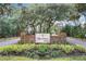 Welcoming community entrance with brick signage, mature trees, and landscaped grounds at 1701 Cedar Stone Ct, Lake Mary, FL 32746