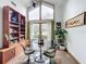 Mid-century modern dining room with glass table and built-in shelving at 1701 Cedar Stone Ct, Lake Mary, FL 32746