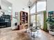 Mid-century modern dining area with a glass table and unique chandelier at 1701 Cedar Stone Ct, Lake Mary, FL 32746