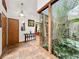 Entryway featuring tile flooring, decor, and a large glass window looking into interior courtyard at 1701 Cedar Stone Ct, Lake Mary, FL 32746