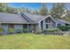 Charming single-story home with blue siding, well-manicured lawn, and vibrant orange front door at 1701 Cedar Stone Ct, Lake Mary, FL 32746