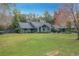 Gray house with a gray roof, landscaping, and a spacious lawn at 1701 Cedar Stone Ct, Lake Mary, FL 32746