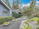 Landscaped walkway leading to the house, with plants and gravel at 1701 Cedar Stone Ct, Lake Mary, FL 32746