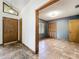Hallway with ceramic tile flooring and an entrance to a bedroom with a closet and window at 1701 Cedar Stone Ct, Lake Mary, FL 32746