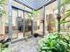 View of indoor atrium with stone and tropical plants plus access to living space at 1701 Cedar Stone Ct, Lake Mary, FL 32746