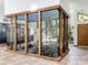 Bright entryway featuring a striking indoor garden with wood framing and lush plants, connecting indoor and outdoor spaces at 1701 Cedar Stone Ct, Lake Mary, FL 32746
