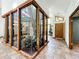 Light-filled foyer featuring a unique, glass-enclosed indoor garden, seamlessly blending nature with modern design at 1701 Cedar Stone Ct, Lake Mary, FL 32746
