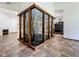 Bright and airy living space featuring a charming indoor garden with glass surround and natural wooden framing at 1701 Cedar Stone Ct, Lake Mary, FL 32746
