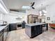 Well-lit kitchen featuring an island with seating, stainless appliances, and stylish cabinetry at 1701 Cedar Stone Ct, Lake Mary, FL 32746