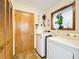 Functional laundry room with washer, dryer, storage closet, and natural light from the window at 1701 Cedar Stone Ct, Lake Mary, FL 32746