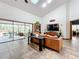 View of the living room with a leather sofa, large windows, and tiled floors at 1701 Cedar Stone Ct, Lake Mary, FL 32746