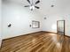 Well-lit living room with hardwood floors, windows and a ceiling fan, providing a cozy atmosphere at 1701 Cedar Stone Ct, Lake Mary, FL 32746