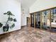 Spacious living room with ceramic tile flooring and large interior atrium at 1701 Cedar Stone Ct, Lake Mary, FL 32746