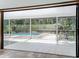 Screened patio with sliding glass doors overlooks a pool and wooded backyard at 1701 Cedar Stone Ct, Lake Mary, FL 32746