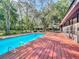 Swimming pool and deck surrounded by beautiful landscaping and mature trees at 1701 Cedar Stone Ct, Lake Mary, FL 32746