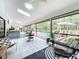 Screened porch with pool view, dining table, and comfy seating at 1701 Cedar Stone Ct, Lake Mary, FL 32746