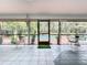 Bright screened porch with pool view, mid-century modern furniture, and tiled floor at 1701 Cedar Stone Ct, Lake Mary, FL 32746